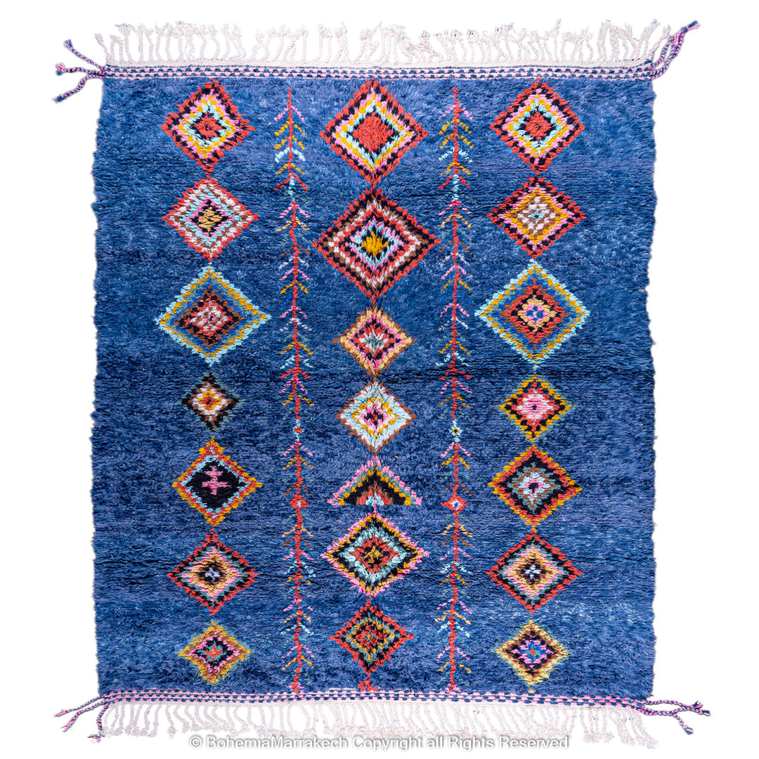 Colorful handmade blue Moroccan rug with diamond tribal designs on plush wool