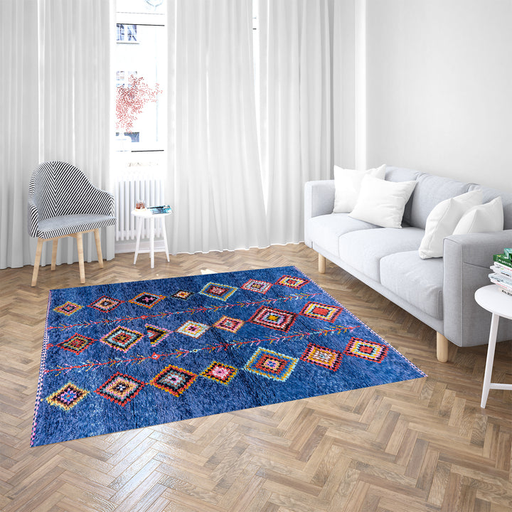 Colorful handmade blue Moroccan rug with diamond tribal designs on plush wool