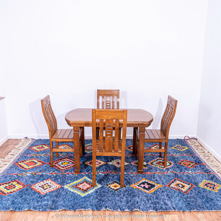 Colorful handmade blue Moroccan rug with diamond tribal designs on plush wool