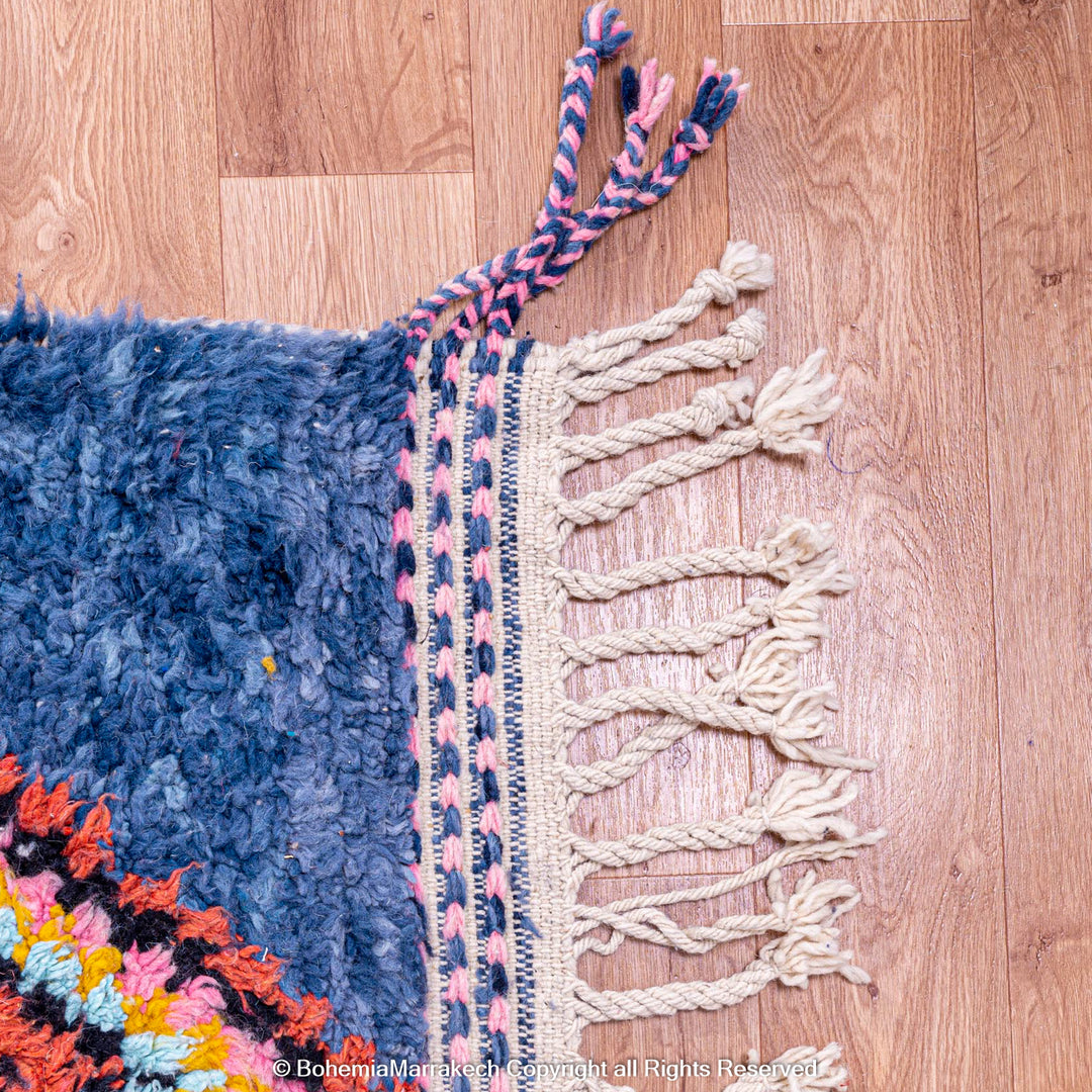 Colorful handmade blue Moroccan rug with diamond tribal designs on plush wool