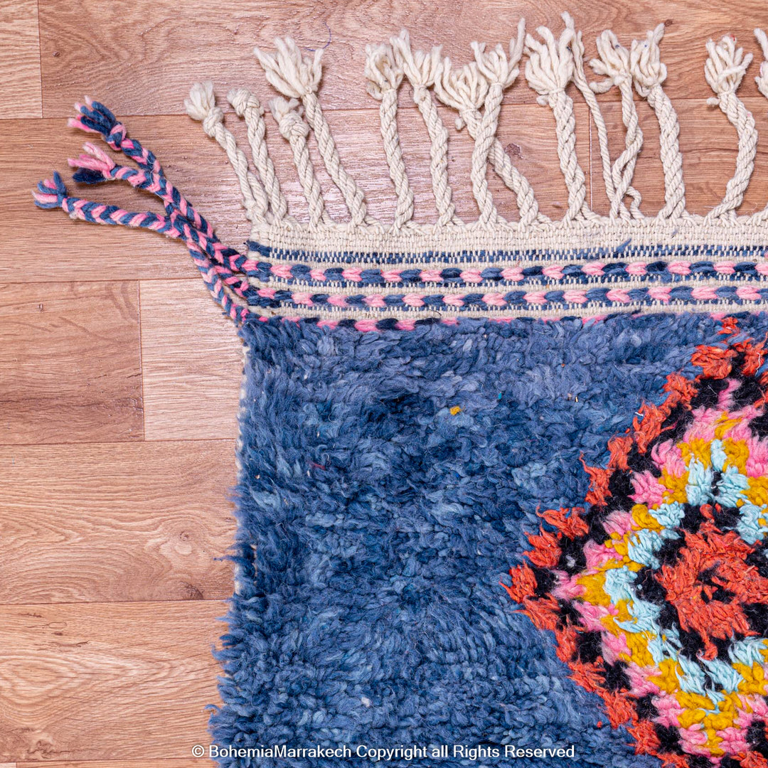 Colorful handmade blue Moroccan rug with diamond tribal designs on plush wool