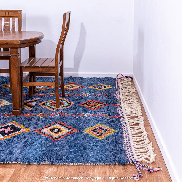 Colorful handmade blue Moroccan rug with diamond tribal designs on plush wool