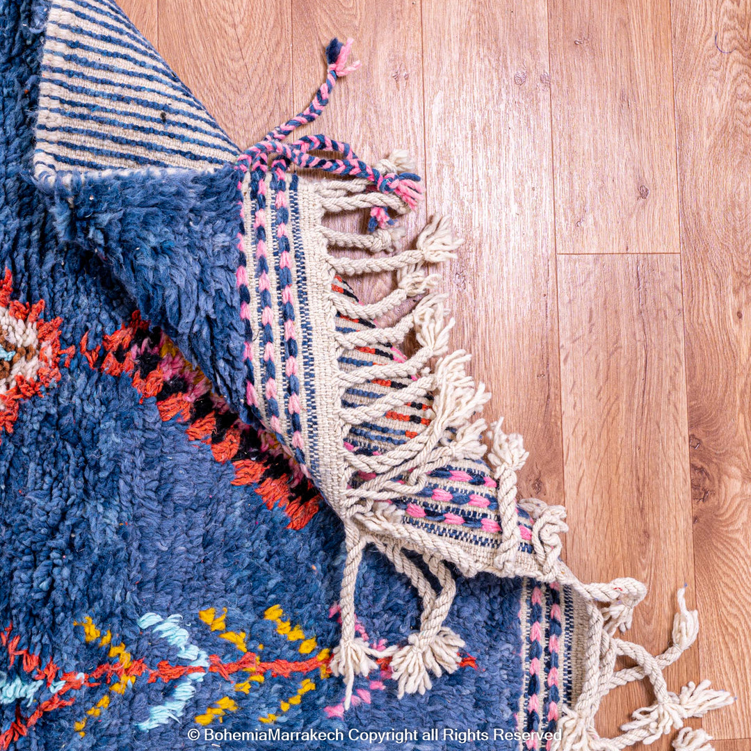 Colorful handmade blue Moroccan rug with diamond tribal designs on plush wool