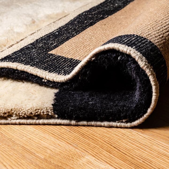 Close-up of Custom Handmade Beni Mrirt Wool Rug featuring traditional Moroccan Berber design, beige and black with thick pile.