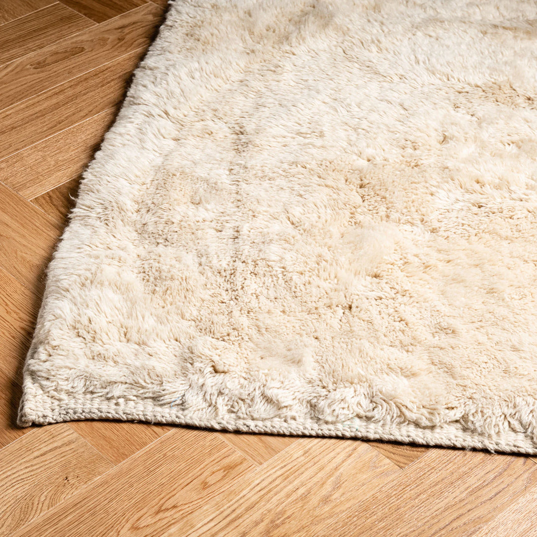 Custom handmade Moroccan rug in creamy ivory wool with plush texture, perfect for modern interiors and minimalistic decor.
