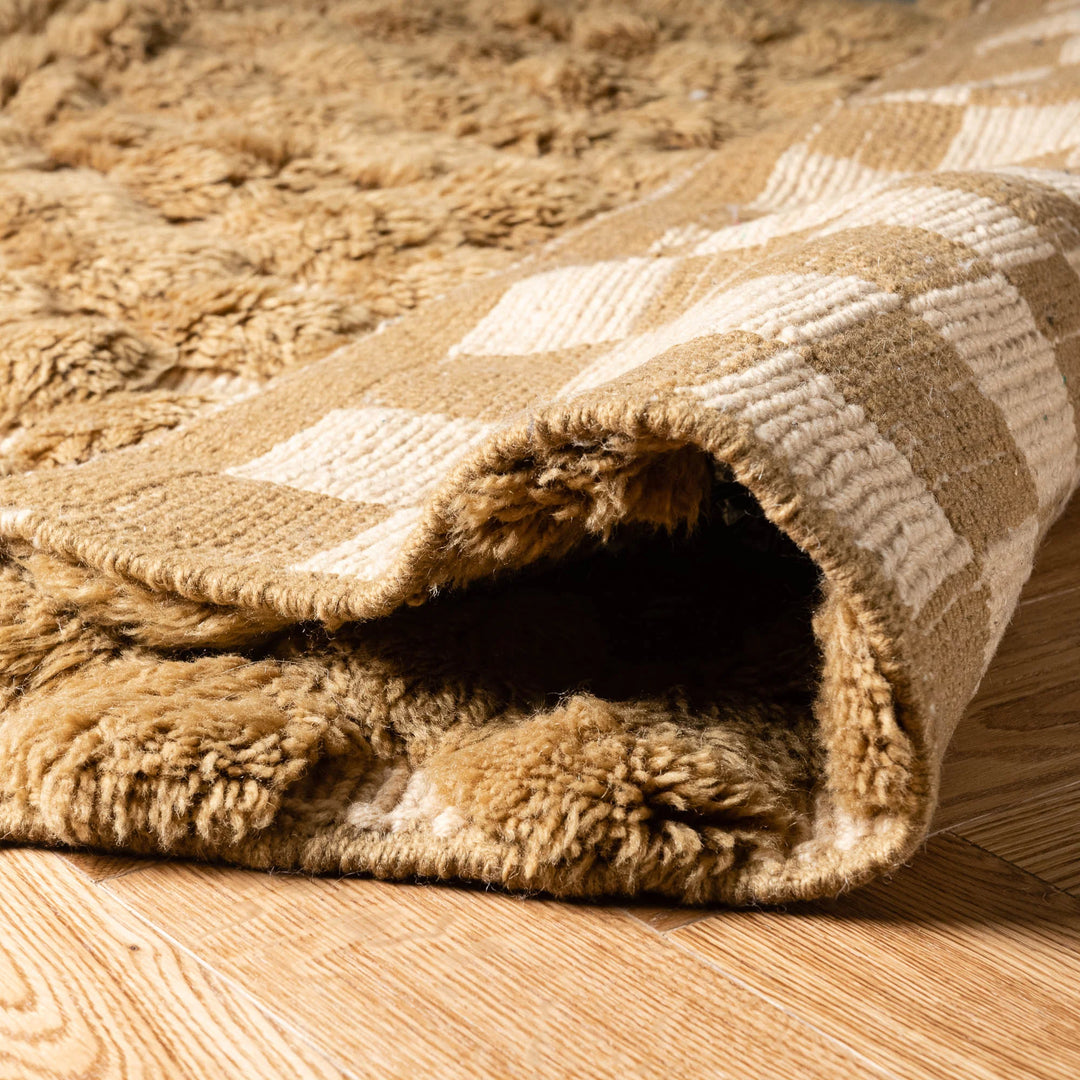 Custom handmade Moroccan rug with textured Berber pattern, featuring tan and cream colors, perfect for modern interiors.