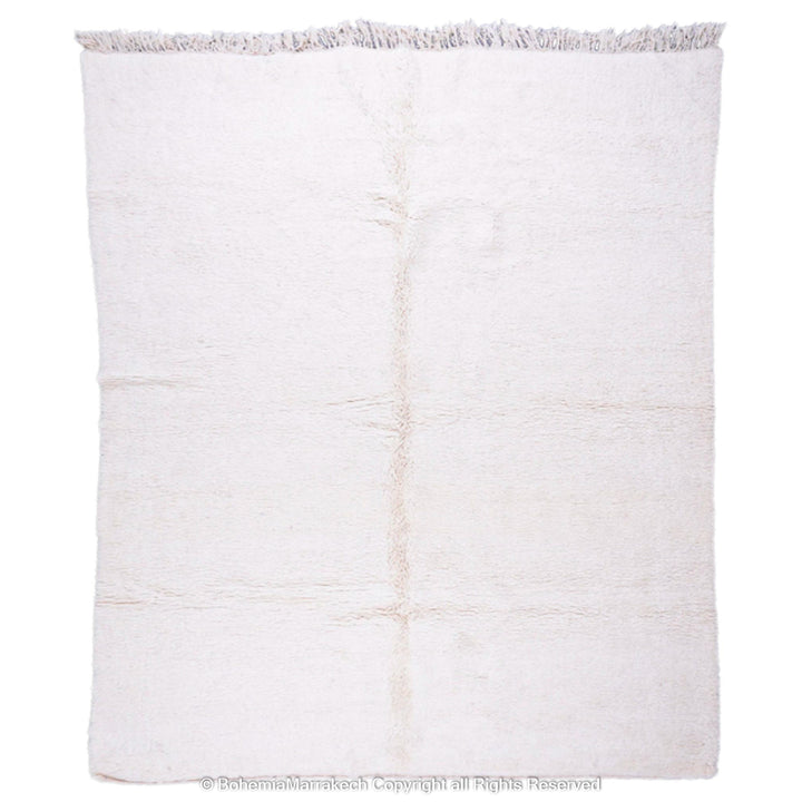 Plain white Moroccan wool Beni Ourain area rug, handmade by Berber artisans, enhances minimalist interiors. Available as an 8x10 rug.
