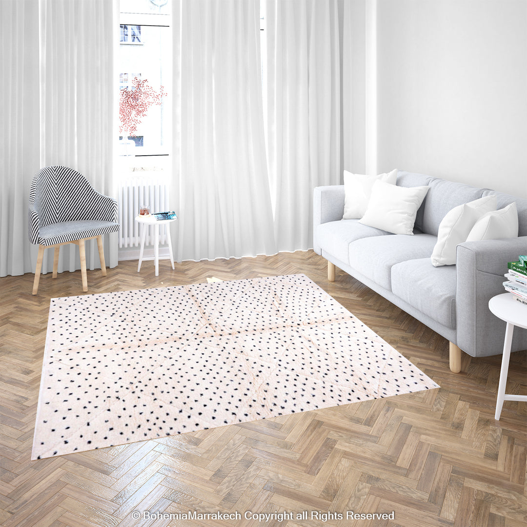 White Moroccan Beni Ourain rug with black dots in modern living room, showcasing traditional Berber craftsmanship and wool texture.