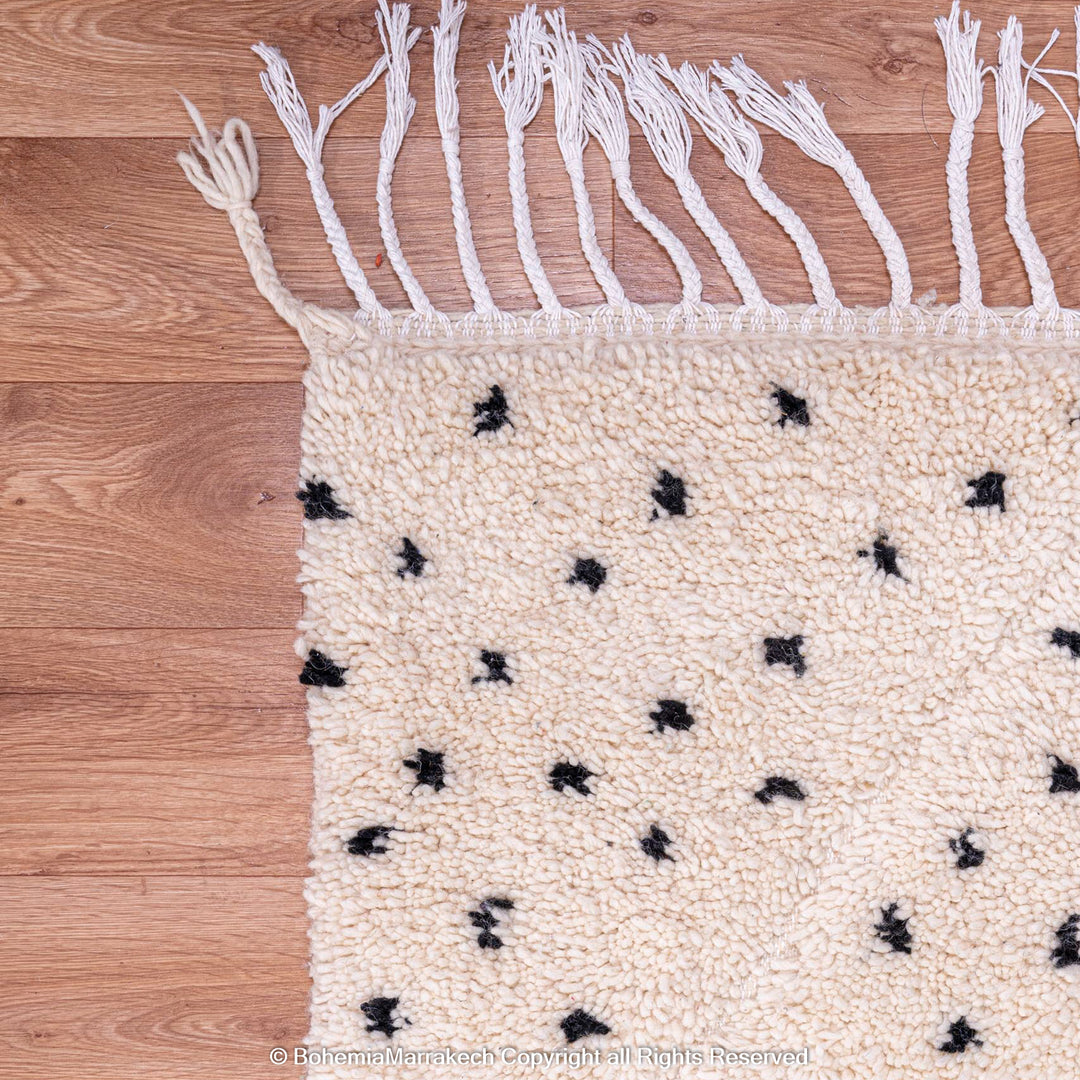White Moroccan Beni Ourain rug with black dots and fringe detail, handcrafted wool area rug, traditional Moroccan carpet style