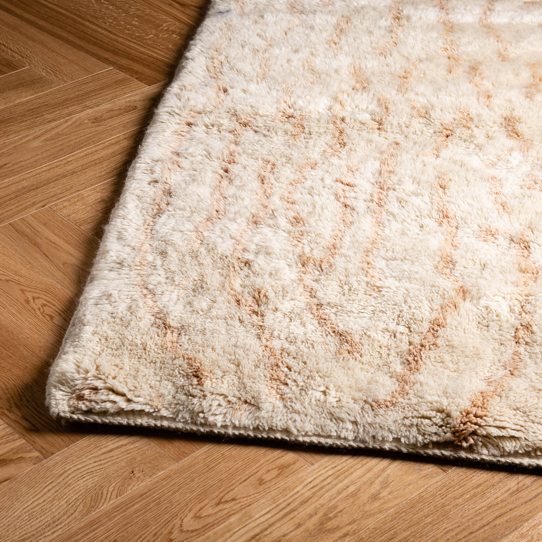 Handwoven Moroccan rug with abstract linework design on wooden floor, elevating interior decor with traditional elegance.