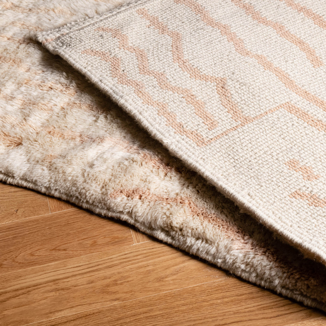 Custom Moroccan rug with abstract linework, handcrafted wool design, ideal for modern or boho interiors, shown on wooden floor.