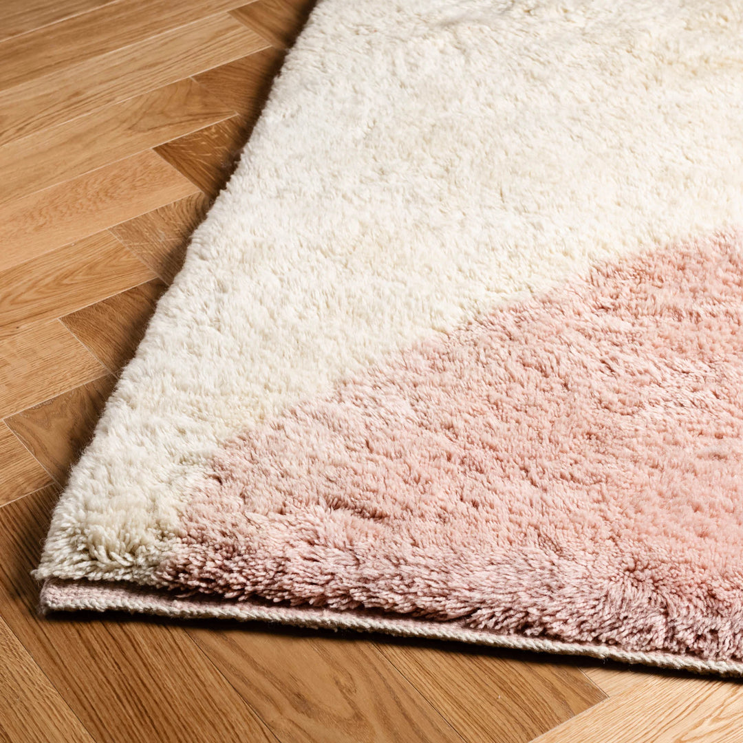 Blush pink and cream Moroccan wool rug, handwoven in abstract design, perfect for bohemian and Scandinavian interiors.