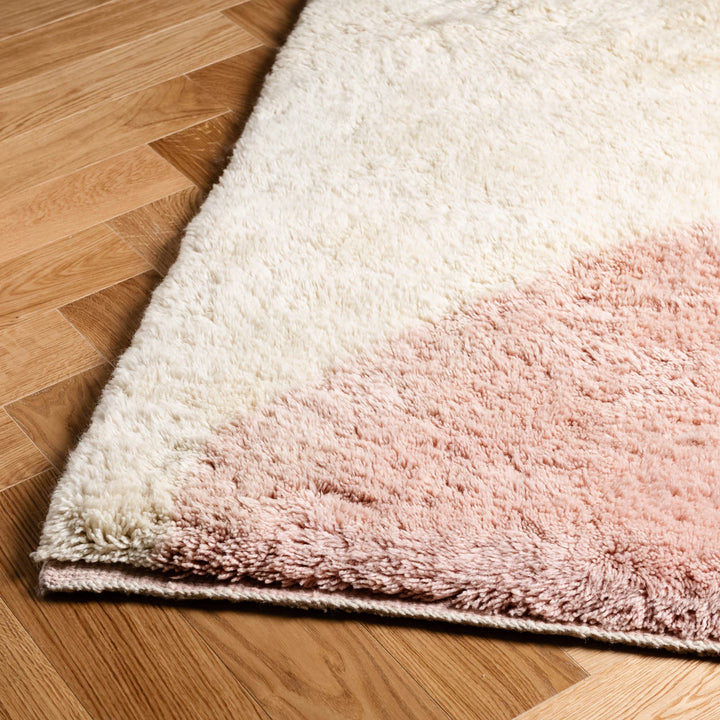 Blush pink and cream Moroccan wool rug, handwoven in abstract design, perfect for bohemian and Scandinavian interiors.