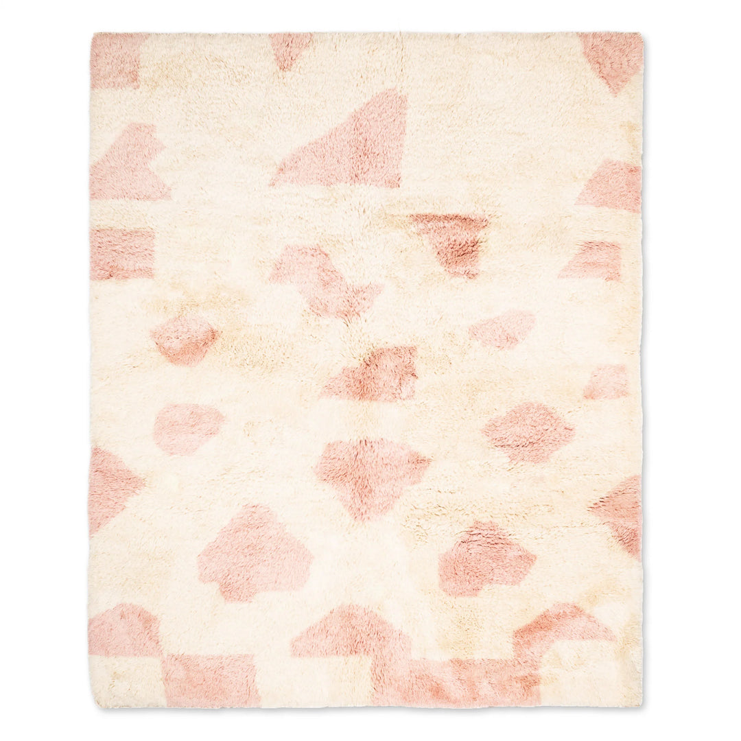 Custom Moroccan rug with soft pink geometric wool design on ivory base, blending abstract art and traditional craftsmanship.