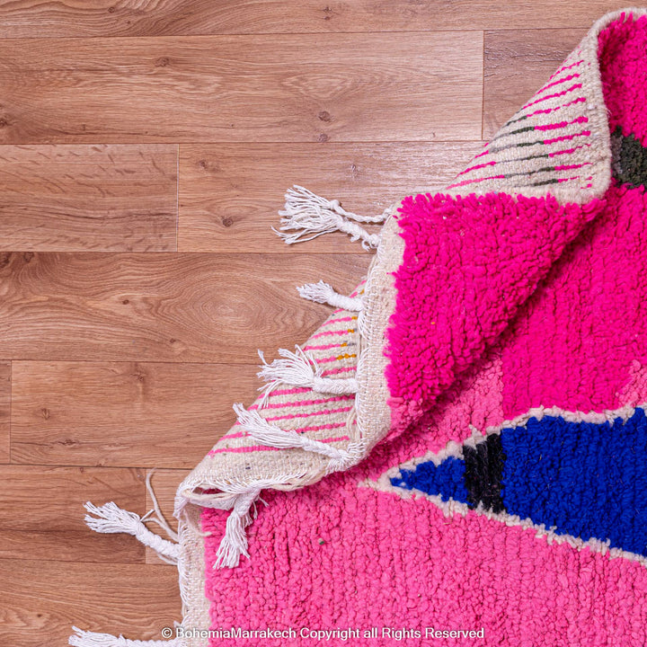 Handmade pink Moroccan rug with multicolor tribal geometric motifs, crafted in wool by Berber artisans
