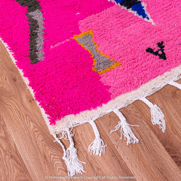 Handmade pink Moroccan rug with multicolor tribal geometric motifs, crafted in wool by Berber artisans