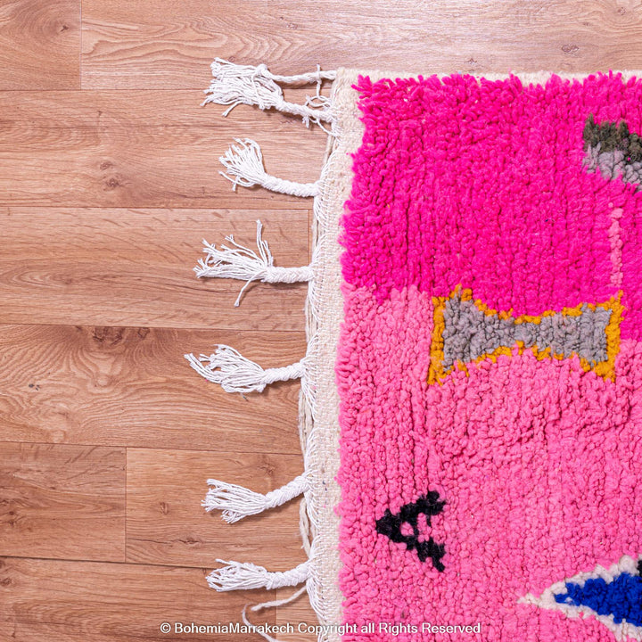 Handmade pink Moroccan rug with multicolor tribal geometric motifs, crafted in wool by Berber artisans