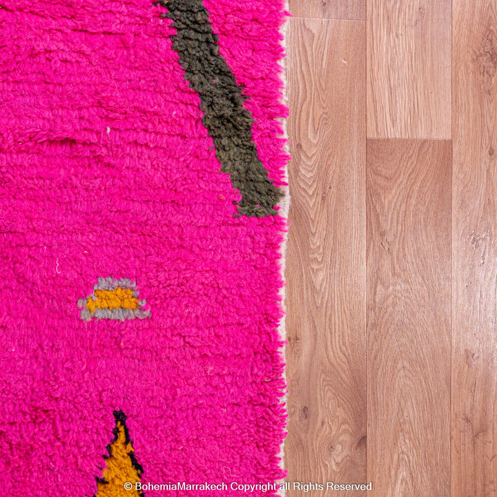 Handmade pink Moroccan rug with multicolor tribal geometric motifs, crafted in wool by Berber artisans