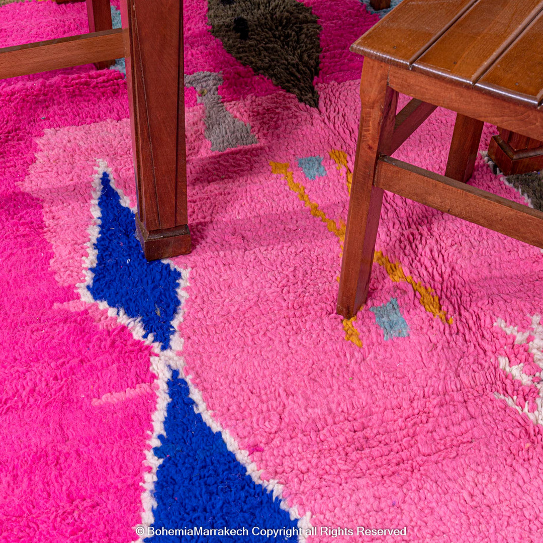 Handmade pink Moroccan rug with multicolor tribal geometric motifs, crafted in wool by Berber artisans