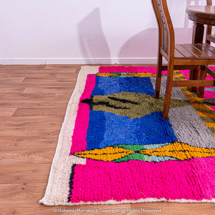 Handmade pink Moroccan rug with multicolor tribal geometric motifs, crafted in wool by Berber artisans