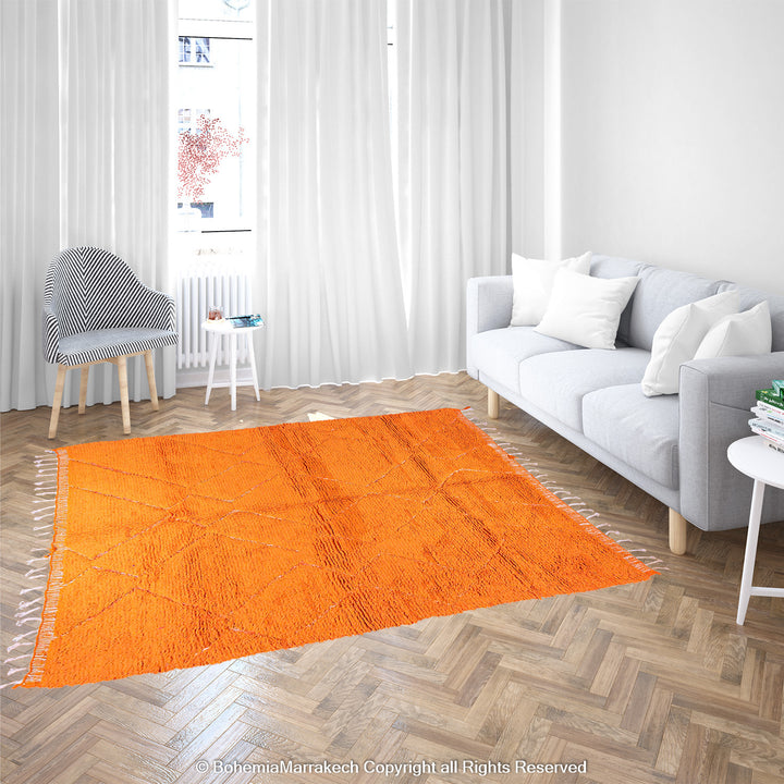 Handmade orange Moroccan rug with subtle diamond pattern and soft wool texture