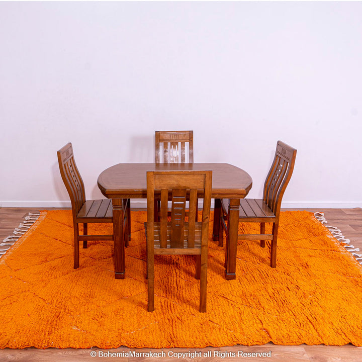 Handmade orange Moroccan rug with subtle diamond pattern and soft wool texture