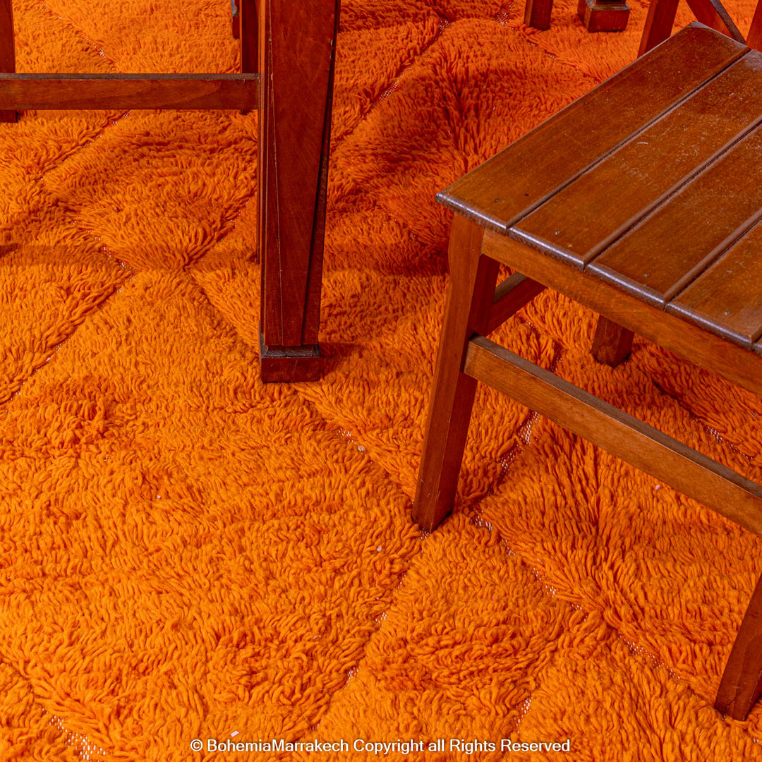 Handmade orange Moroccan rug with subtle diamond pattern and soft wool texture