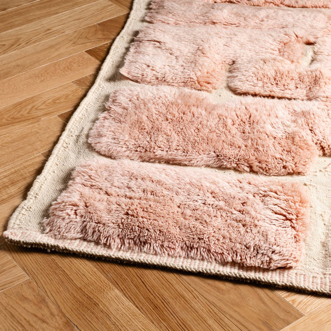 Soft pink Moroccan wool rug with modern brick pattern, ideal for cozy interiors. Handcrafted luxury area rug with plush texture.
