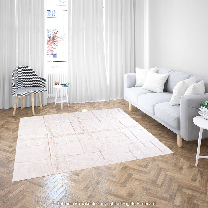 Off-white Moroccan Berber rug with geometric pattern in modern living room, blending minimalist style with traditional craftsmanship.