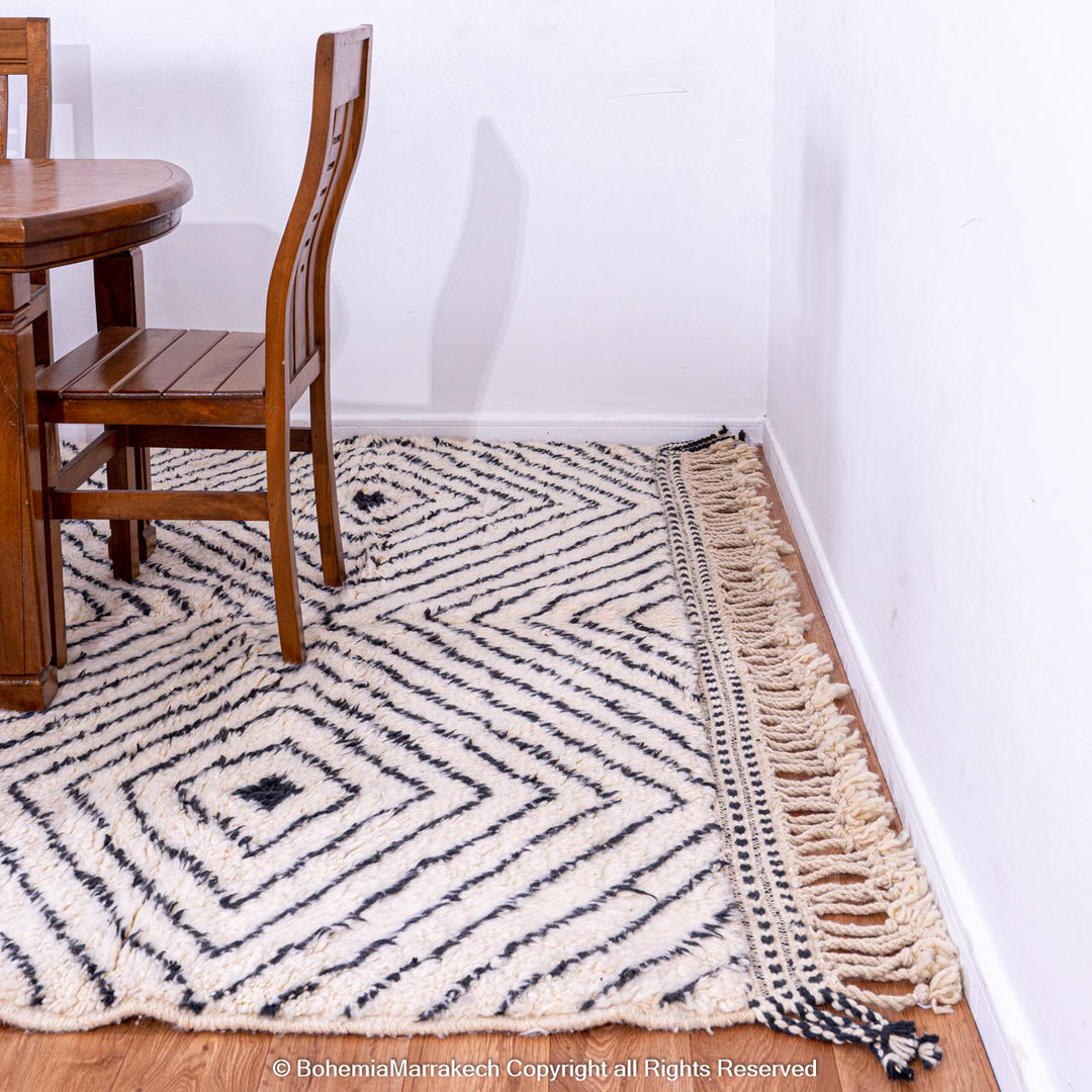 White Moroccan rug with black diamond lines, handwoven wool from the Atlas Mountains, perfect for adding elegance to any room.