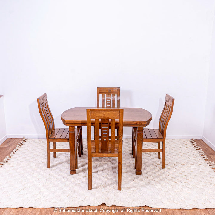 Wood dining set on a white checkered Moroccan wool rug, adding warmth and subtle texture to a minimal, Scandinavian-style room.