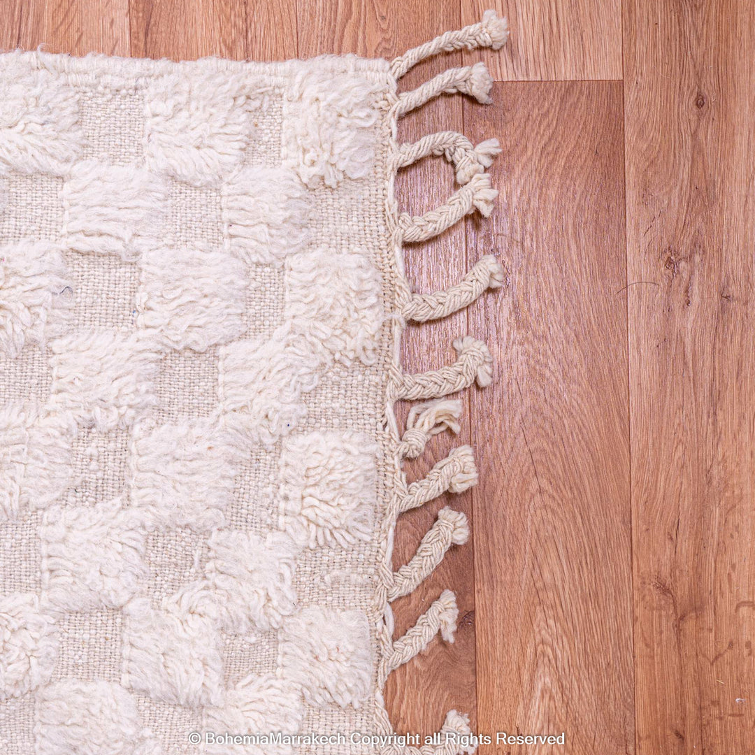 White Checkered Moroccan Berber Wool Rug on Hardwood Floor