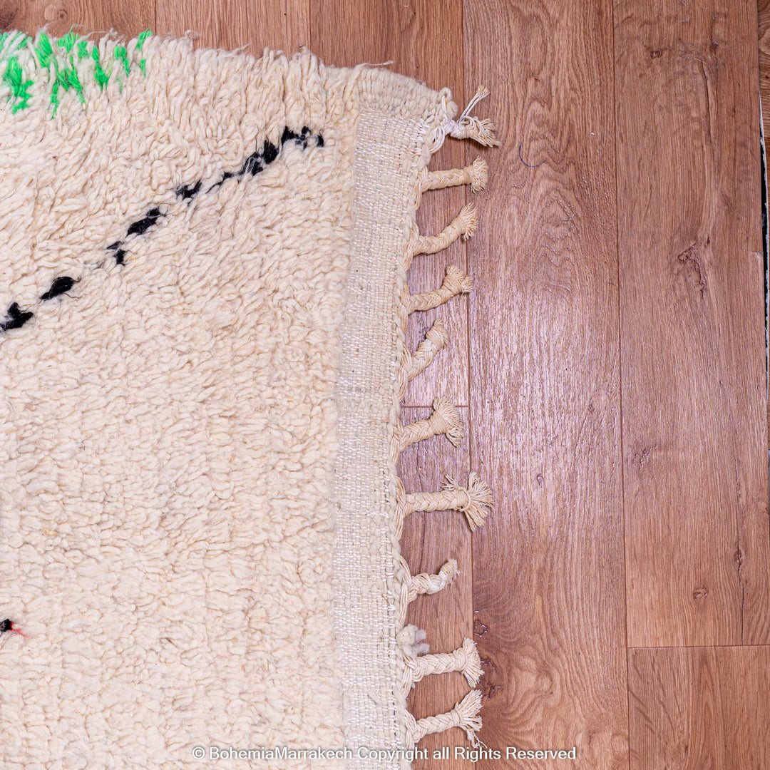 White Moroccan wool rug with multicolor tribal symbols and diamond pattern