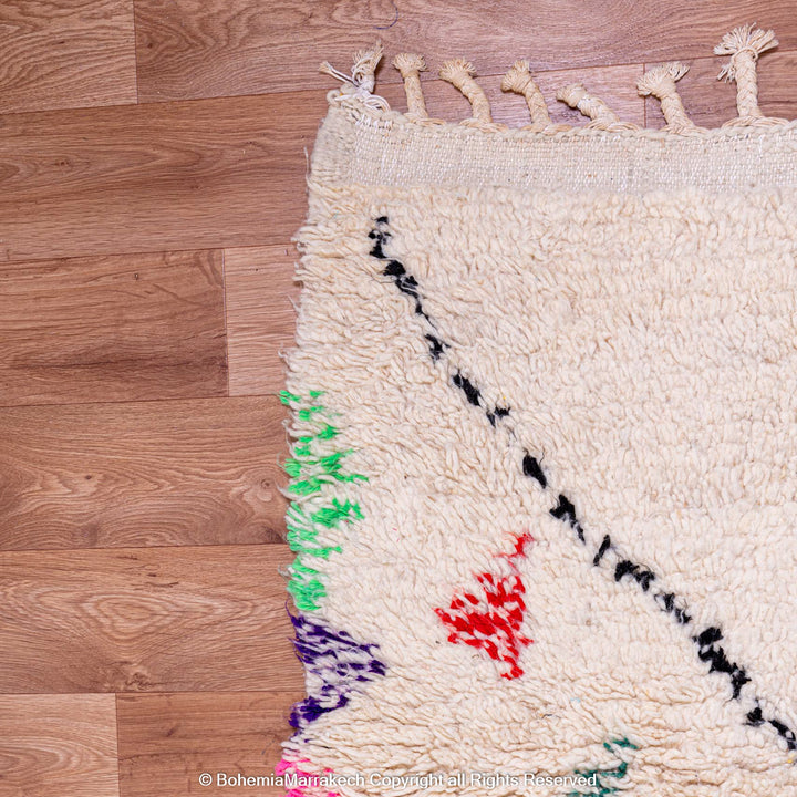 White Moroccan wool rug with multicolor tribal symbols and diamond pattern
