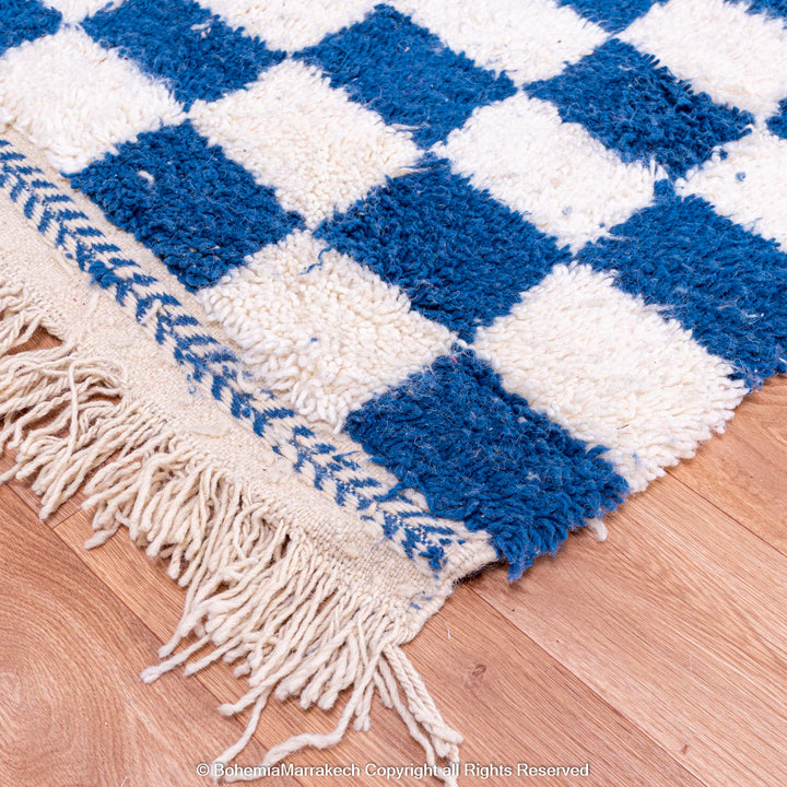 Blue and white checkered Moroccan wool rug with plush shag texture