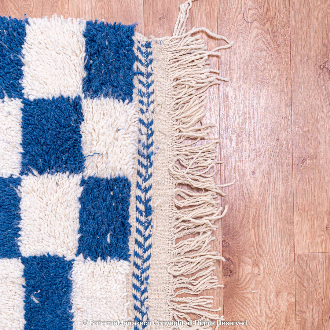 Blue and white checkered Moroccan wool rug with plush shag texture