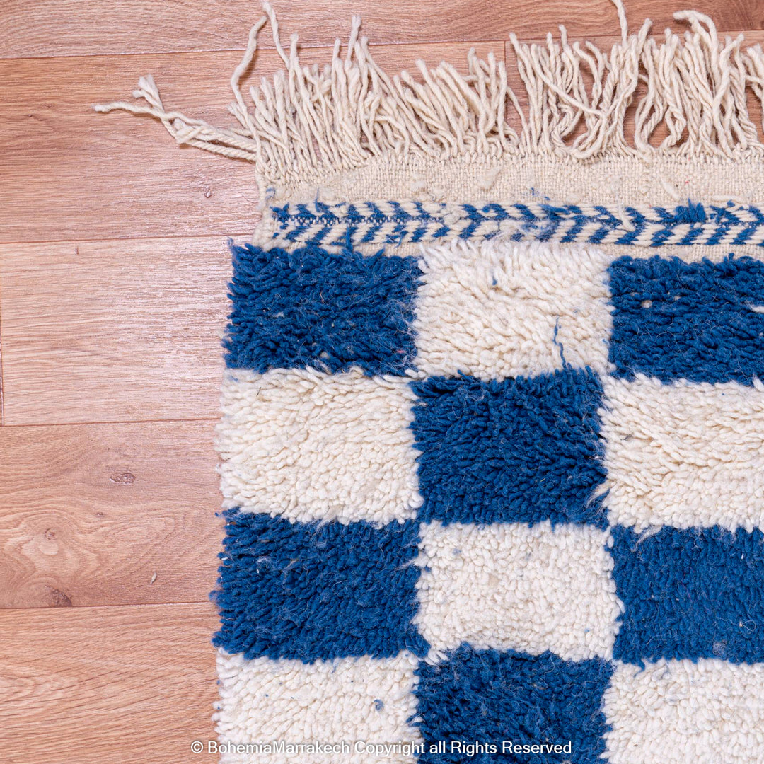 Blue and white checkered Moroccan wool rug with plush shag texture