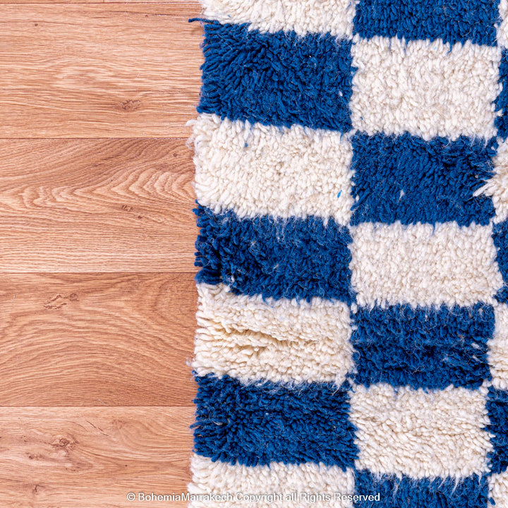 Blue and white checkered Moroccan wool rug with plush shag texture
