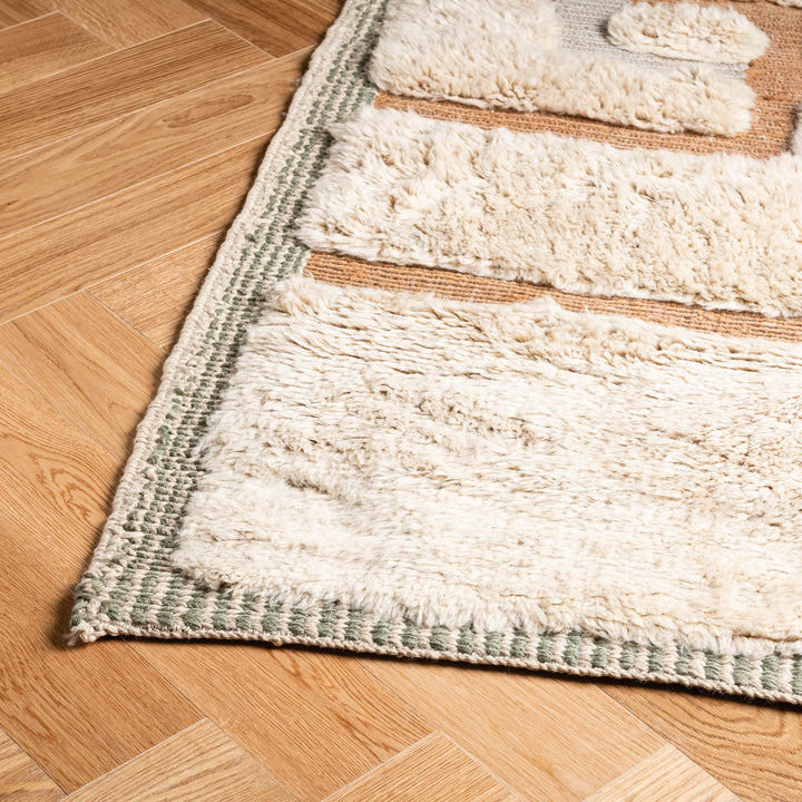 Geometric Beni Mrirt wool rug in beige and earth tones on wooden floor; Moroccan Berber style, handwoven, luxurious home decor.