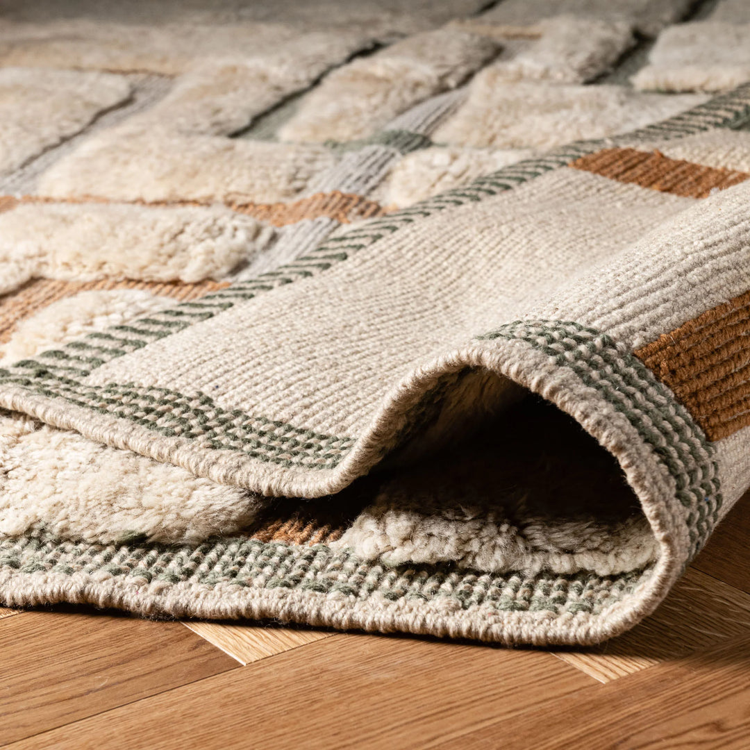 Geometric Beni Mrirt Moroccan wool rug in beige with terracotta and sage accents, showcasing luxury and traditional craftsmanship.