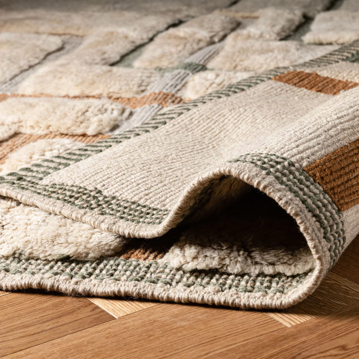 Geometric Beni Mrirt Moroccan wool rug in beige with terracotta and sage accents, showcasing luxury and traditional craftsmanship.