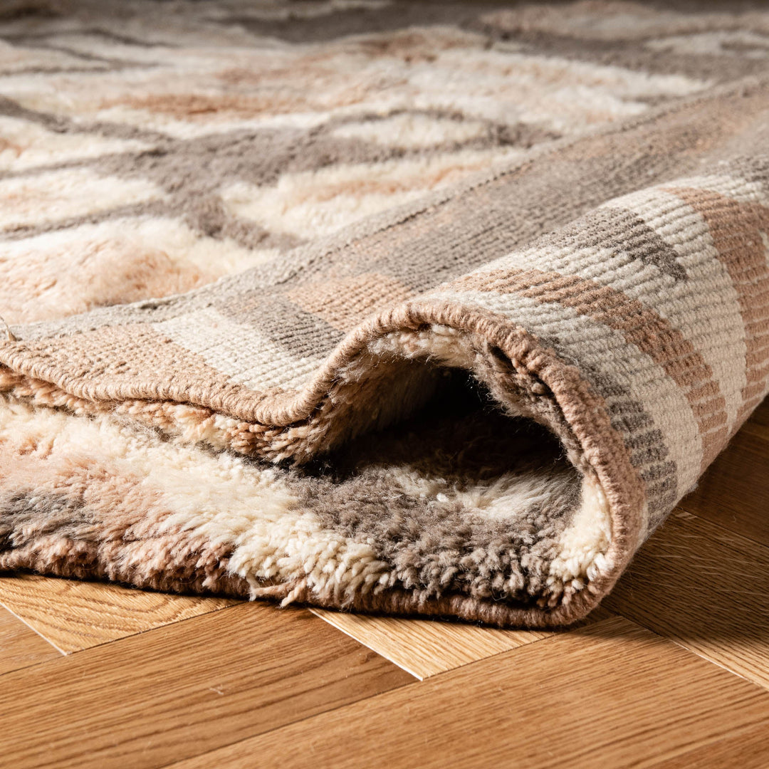 Close-up of a handwoven geometric Moroccan wool rug, showcasing the plush texture and traditional design, ideal for adding warmth and style.