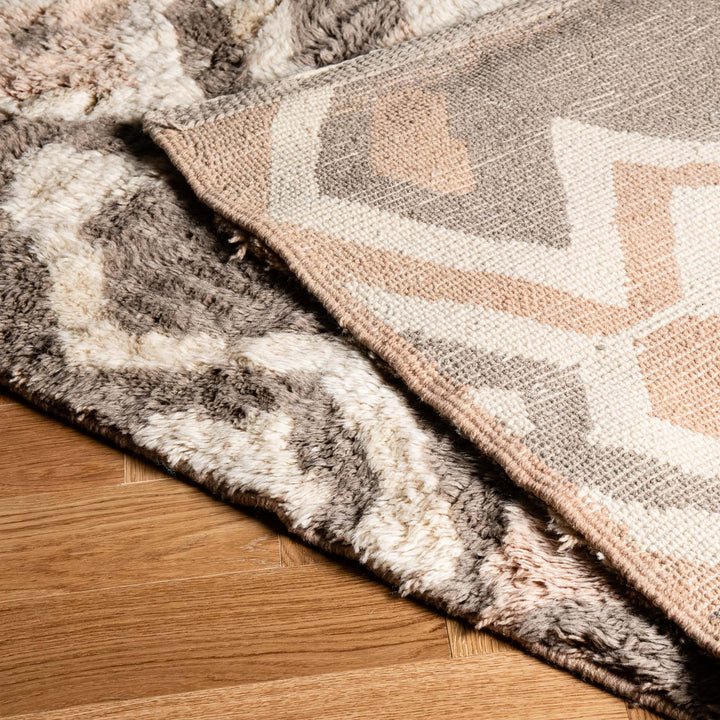 Close-up of a geometric Moroccan wool rug, showcasing a handwoven design with diamond patterns and plush texture.