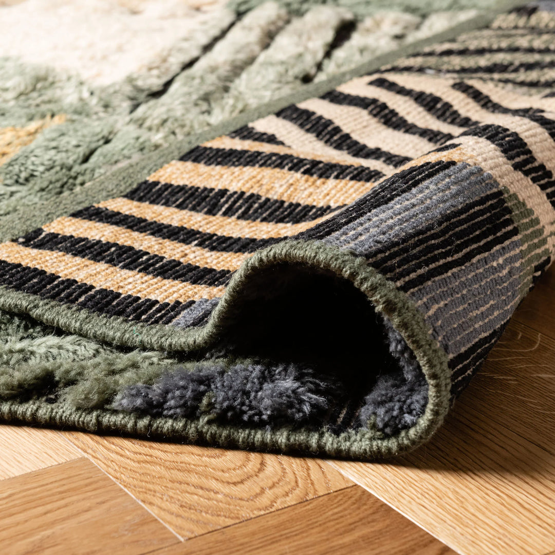 Geometric Moroccan wool rug with stripes, handmade patchwork design in green and earthy tones, showcasing Berber artistry.