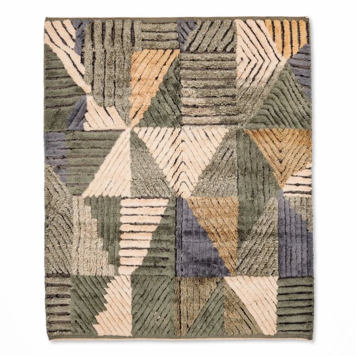 Geometric Moroccan wool rug with handmade patchwork in earthy greens, creams, ochres, and blues; traditional Berber style.