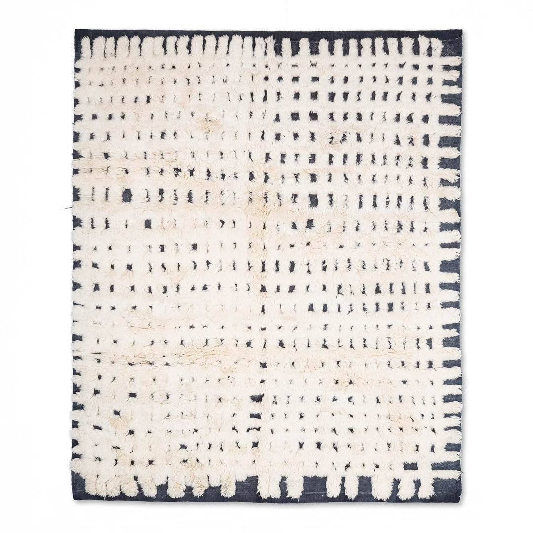 Cream Moroccan rug with black dotted grid pattern, handcrafted from natural wool. Perfect Moroccan Berber carpet for modern homes.