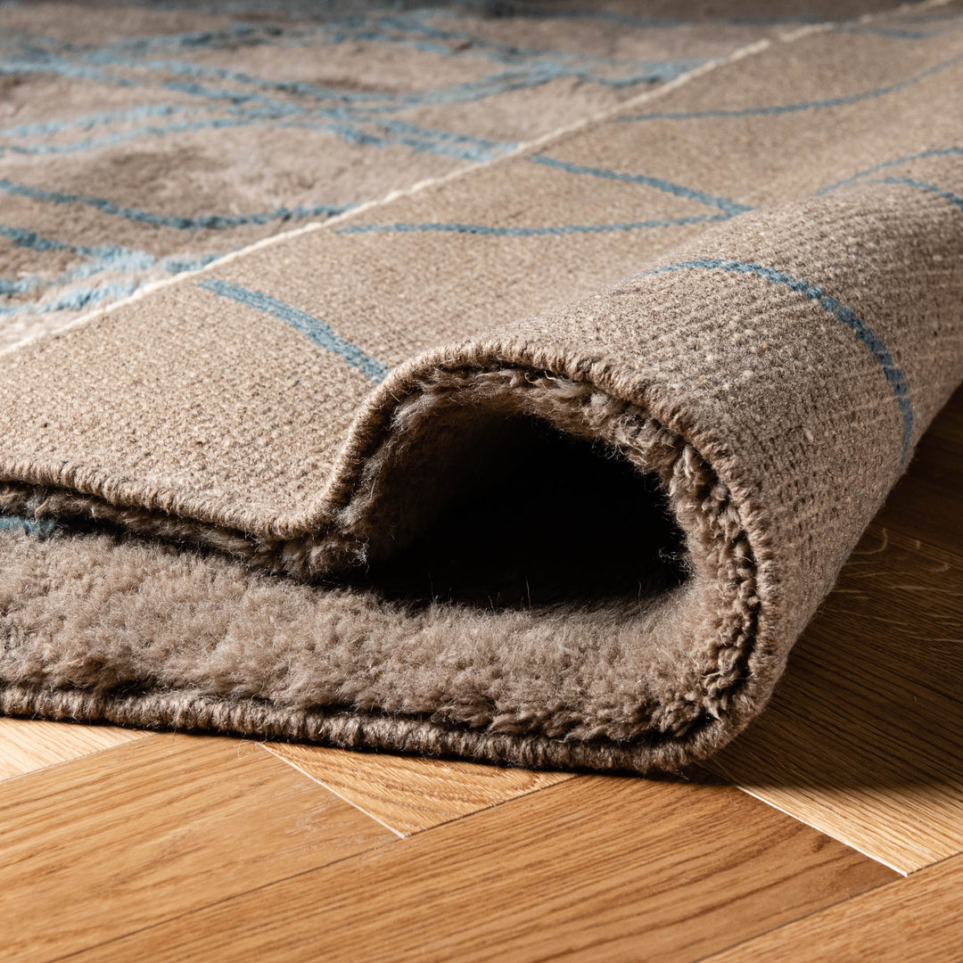 Handmade Moroccan wool rug with traditional diamond line pattern, close-up view.