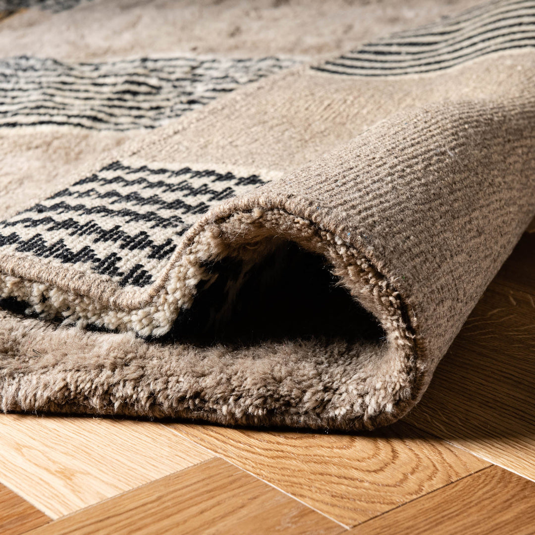 Close-up of a handmade Moroccan wool rug with a geometric line pattern, ideal as a traditional Moroccan carpet or Berber rug.