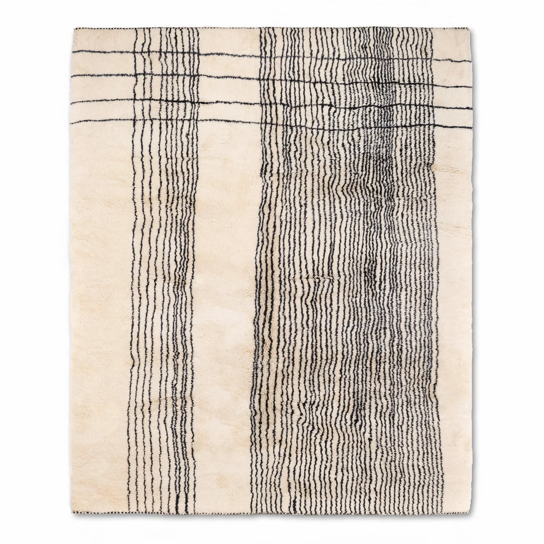 Handmade Moroccan wool rug with organic vertical line pattern, black lines on ivory base, perfect for a modern minimalist look.