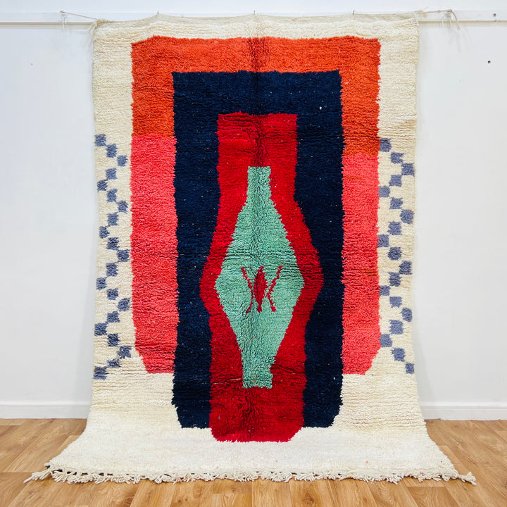 Vintage Moroccan Berber rug, 8x5 ft, handmade wool carpet with green lozenge motif and vibrant red, navy, orange blocks.